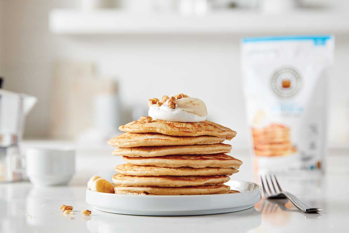Stack of gluten-free protein pancakes with package in background