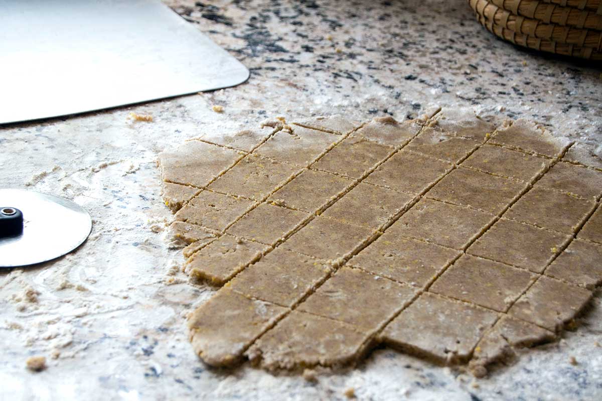 Cut cookie dough on counter next to giant spatula