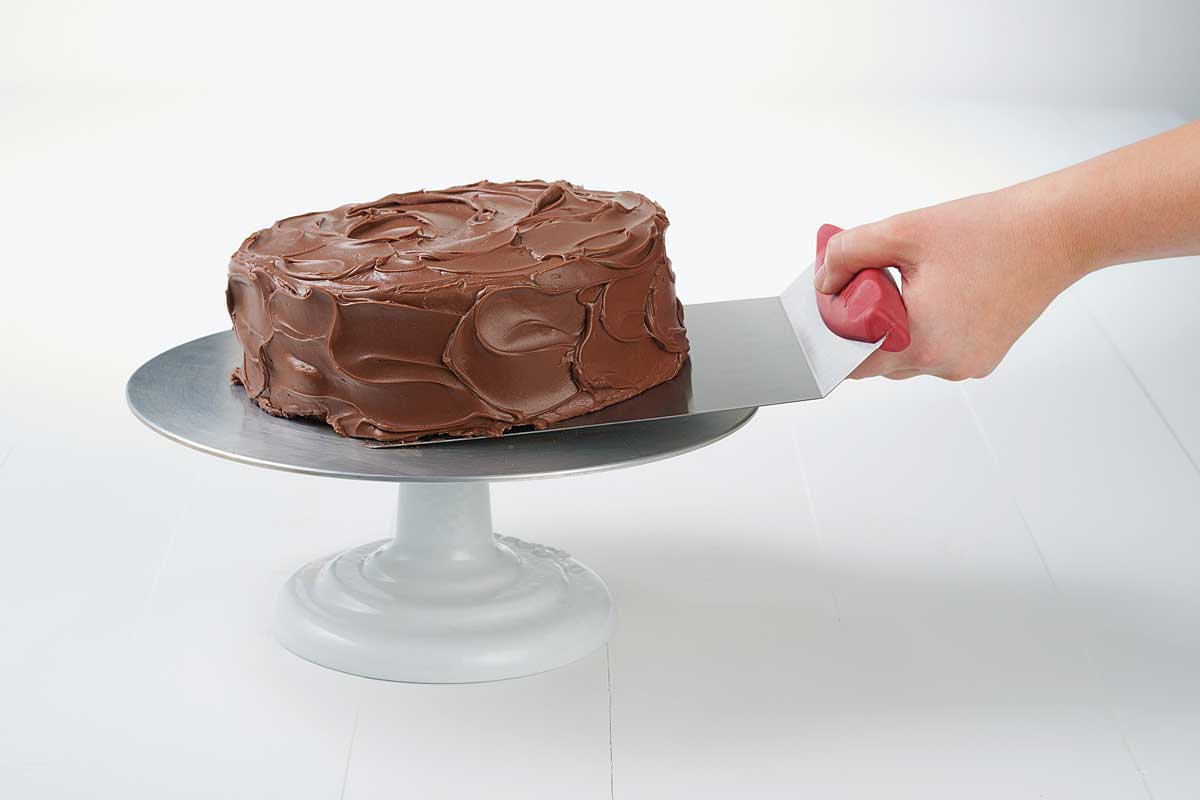 Giant spatula lifting cake