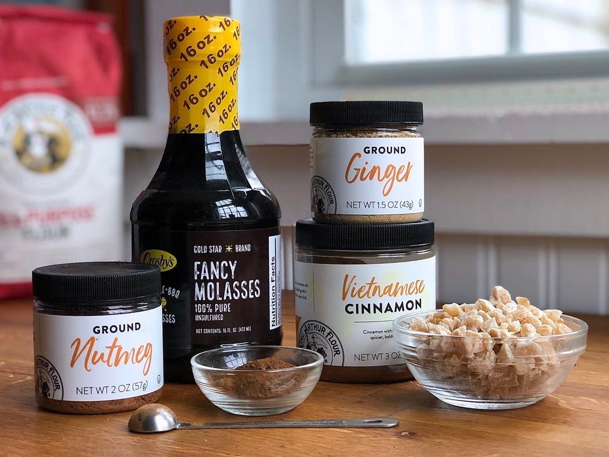 Ingredients for gingerbread lined up on a counter.