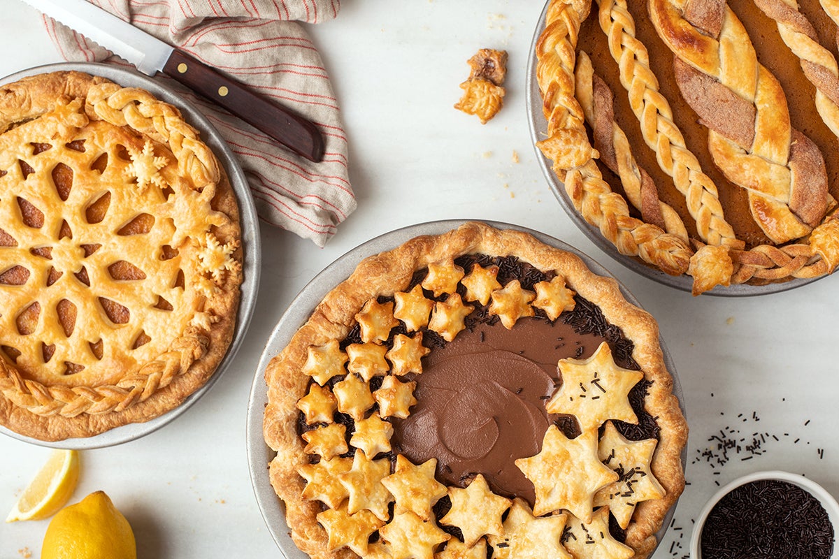 Three custard pies with top crusts on a table