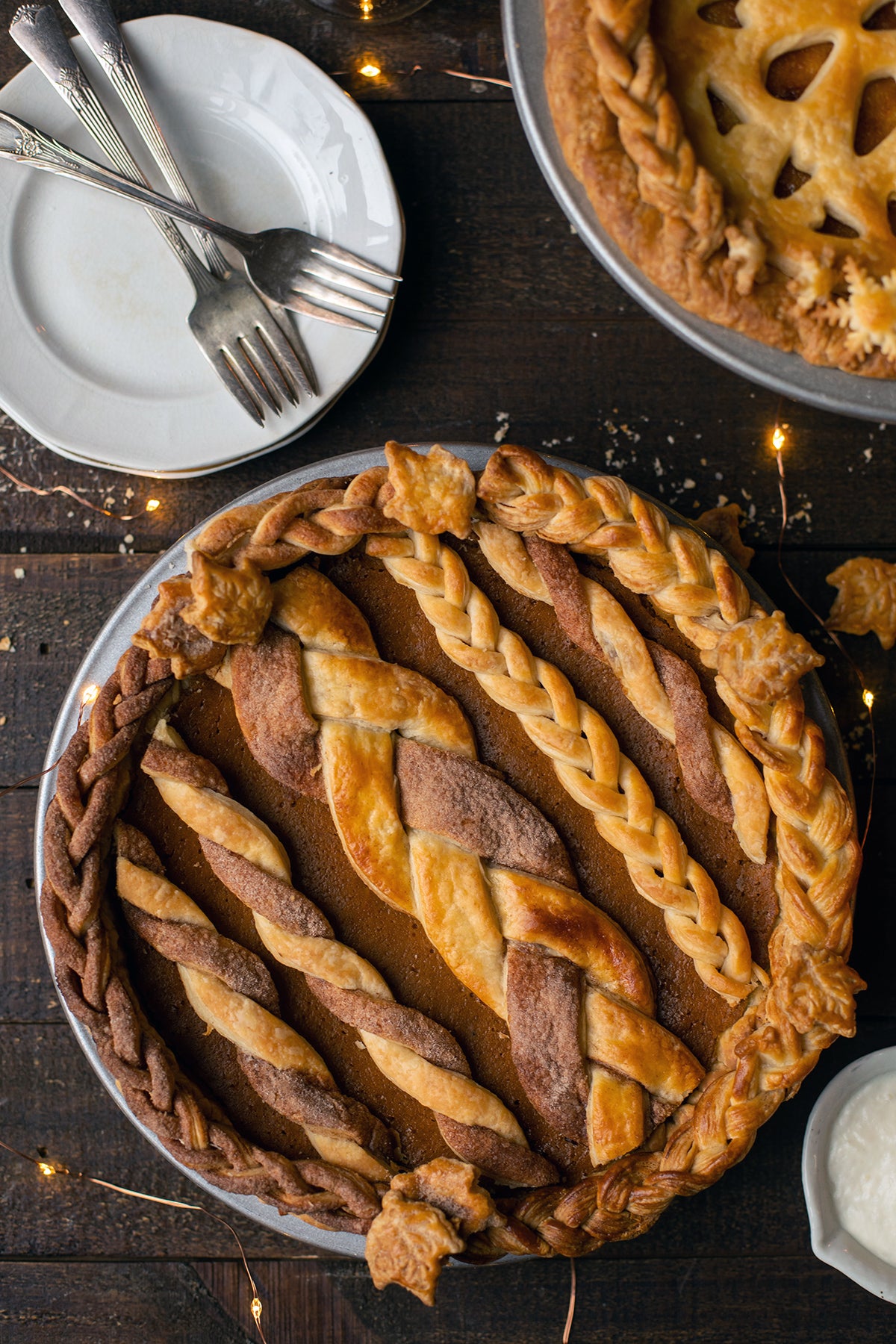 A decorated pumpkin pie on a holiday table