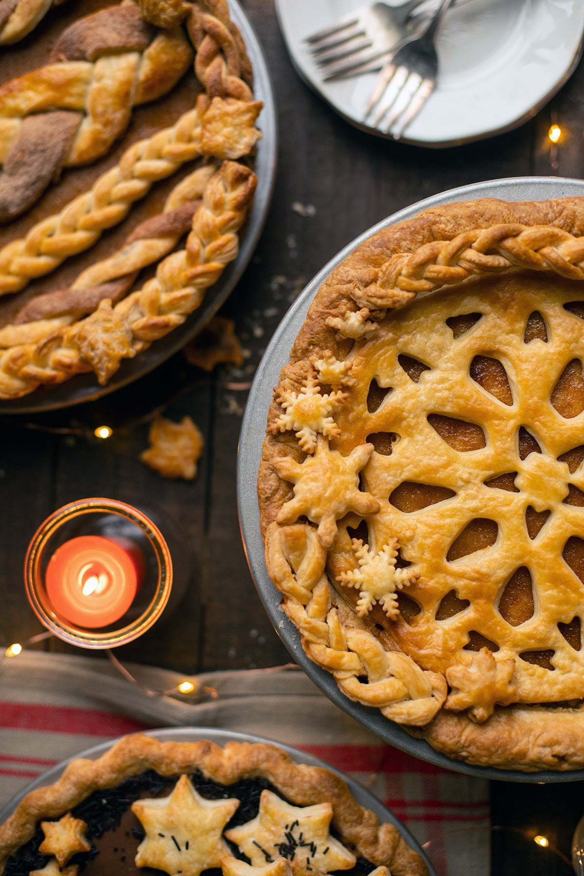 A lemon chess pie with a stencil top crust on a holiday table