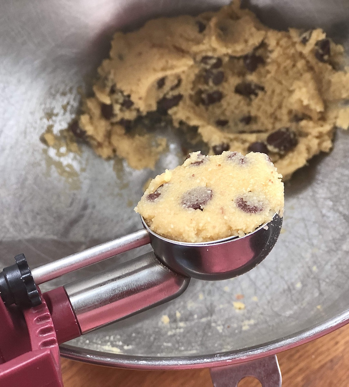 Scooping dough for Gluten-Free Almond Flour Chocolate Chip Cookies using a tablespoon cookie scoop.