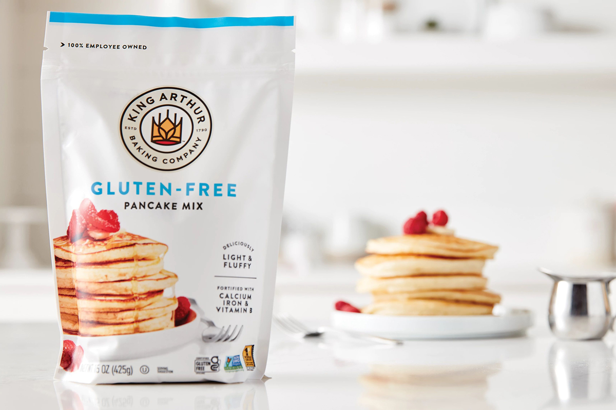 Stack of pancakes with gluten-free mix package in background