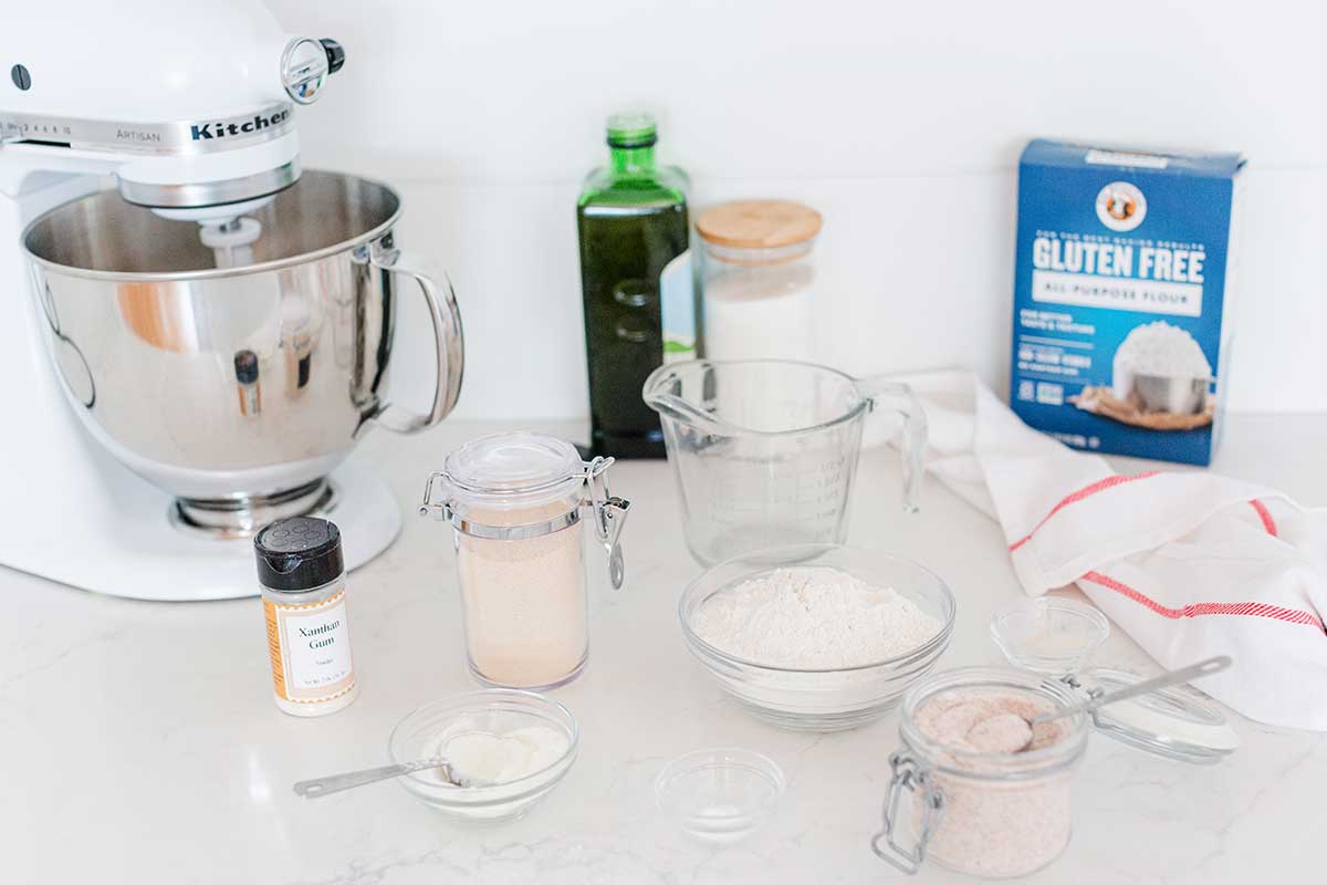 A kitchen scene with Gluten-Free All-Purpose Flour and the ingredients necessary to make a Gluten-Free Pan Pizza