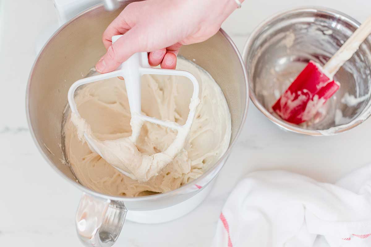Gluten-Free Pan Pizza dough being mixed up in a stand mixer with a paddle attachment showing the soft texure