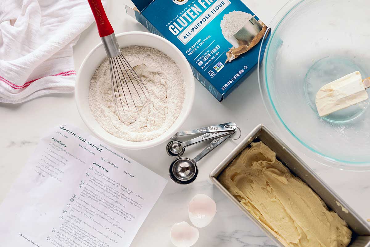 A bowl of gluten-free flour and a recipe for Gluten-Free Sandwich Bread in a kitchen that was recently used for baking