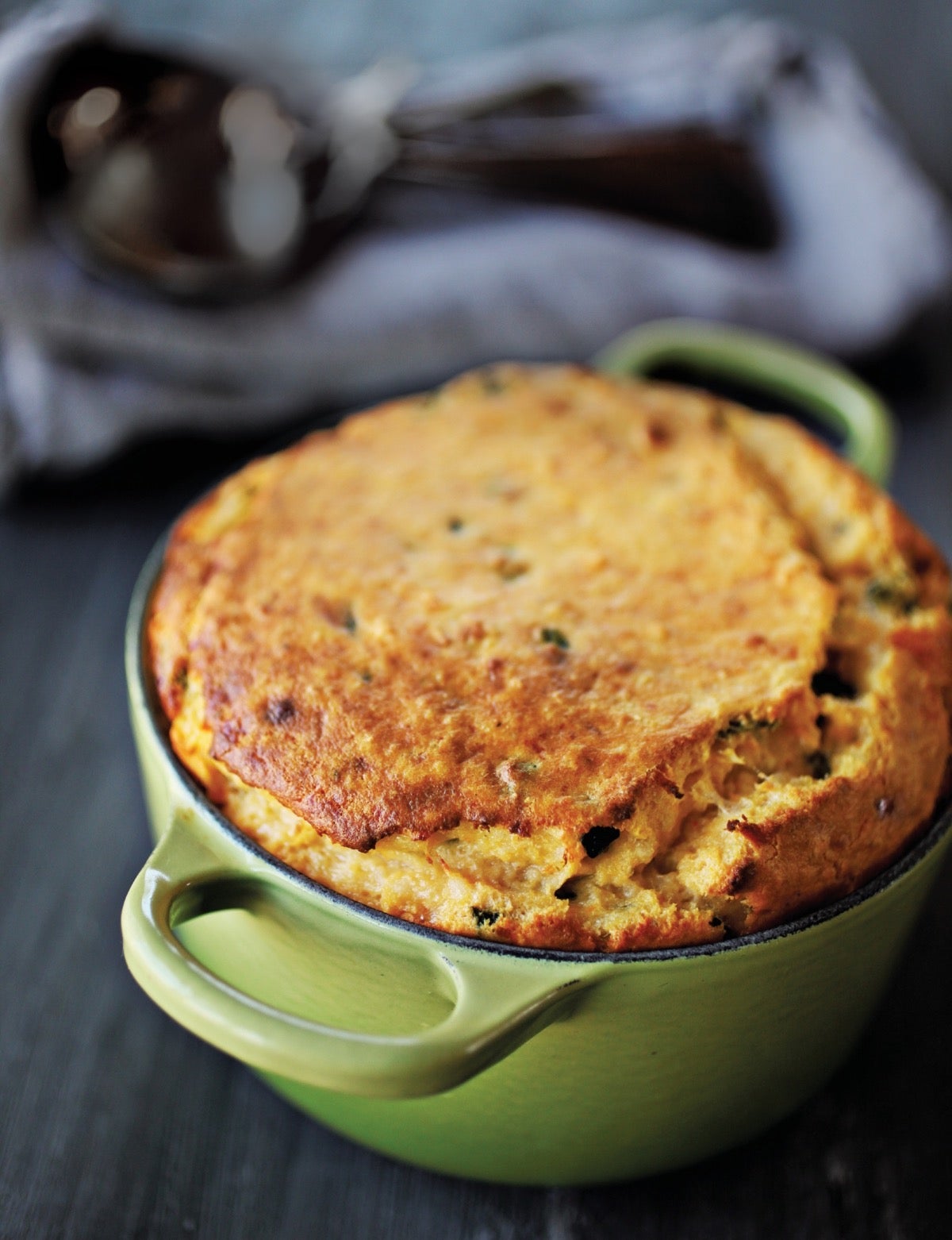 Golden sweet potato spoonbread baked in a crock.