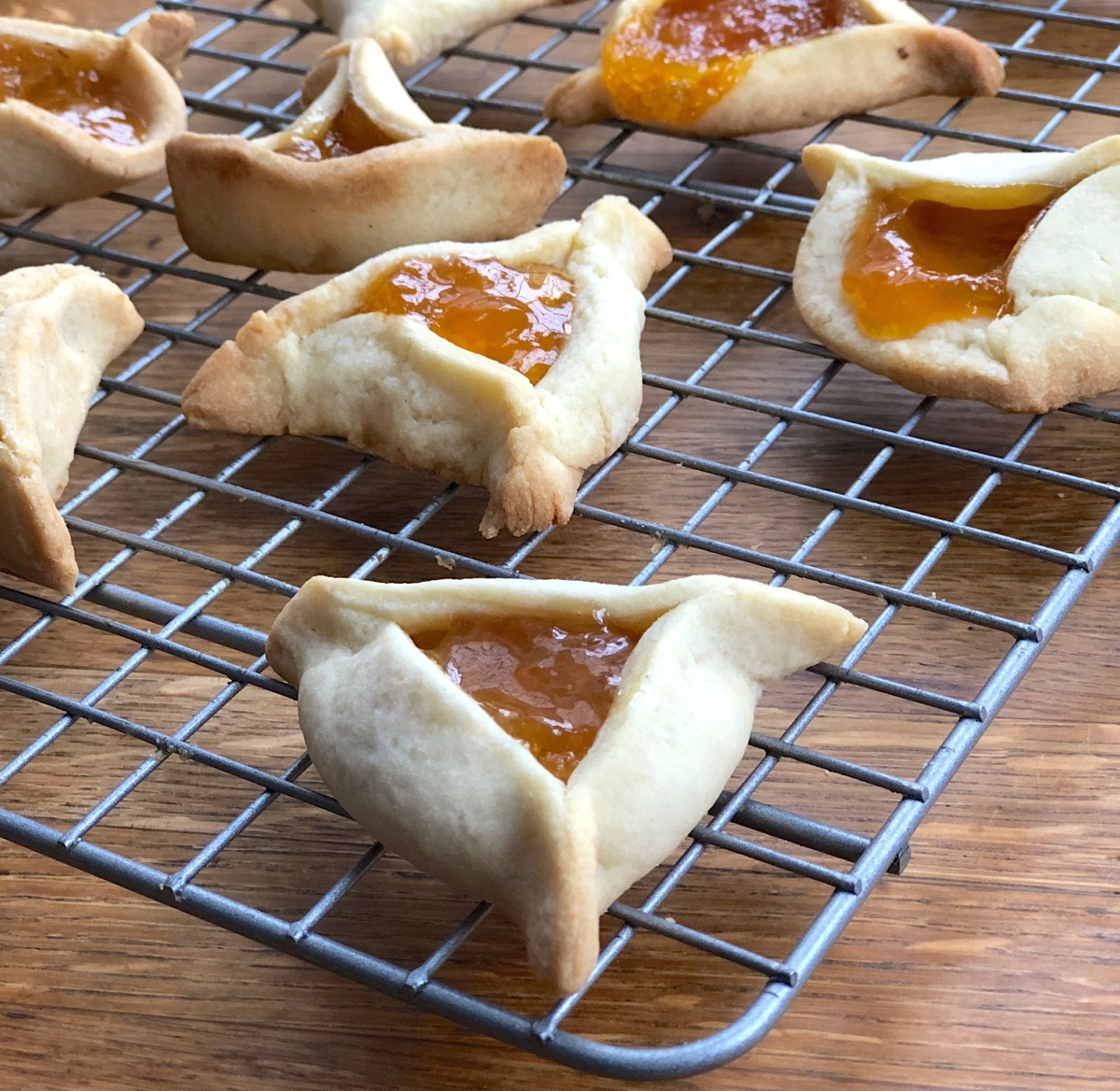 Hamantaschen cooling on a rack.