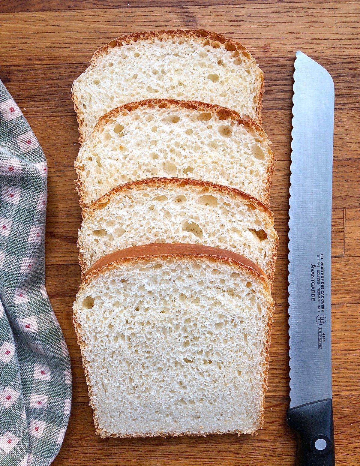 Slices of sandwich bread with a knife and napkin.