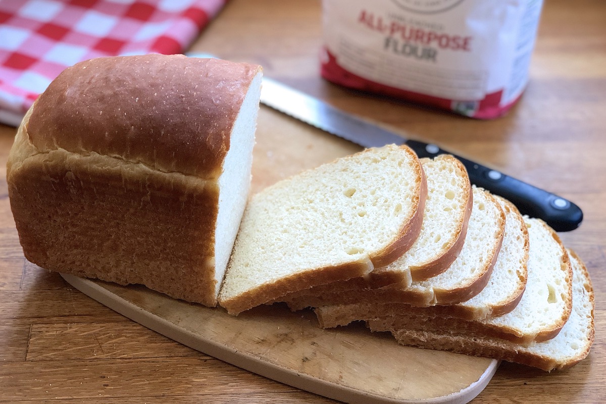 King Arthur's Classic White Sandwich Bread sliced on a cutting board.