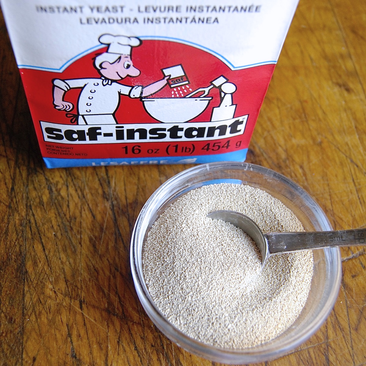 Bag of SAF Red yeast and bowl of yeast with teaspoon