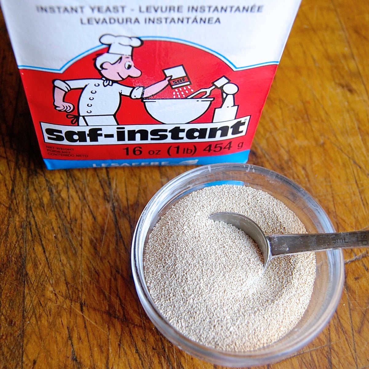 Bag of SAF Red yeast and bowl of yeast with teaspoon