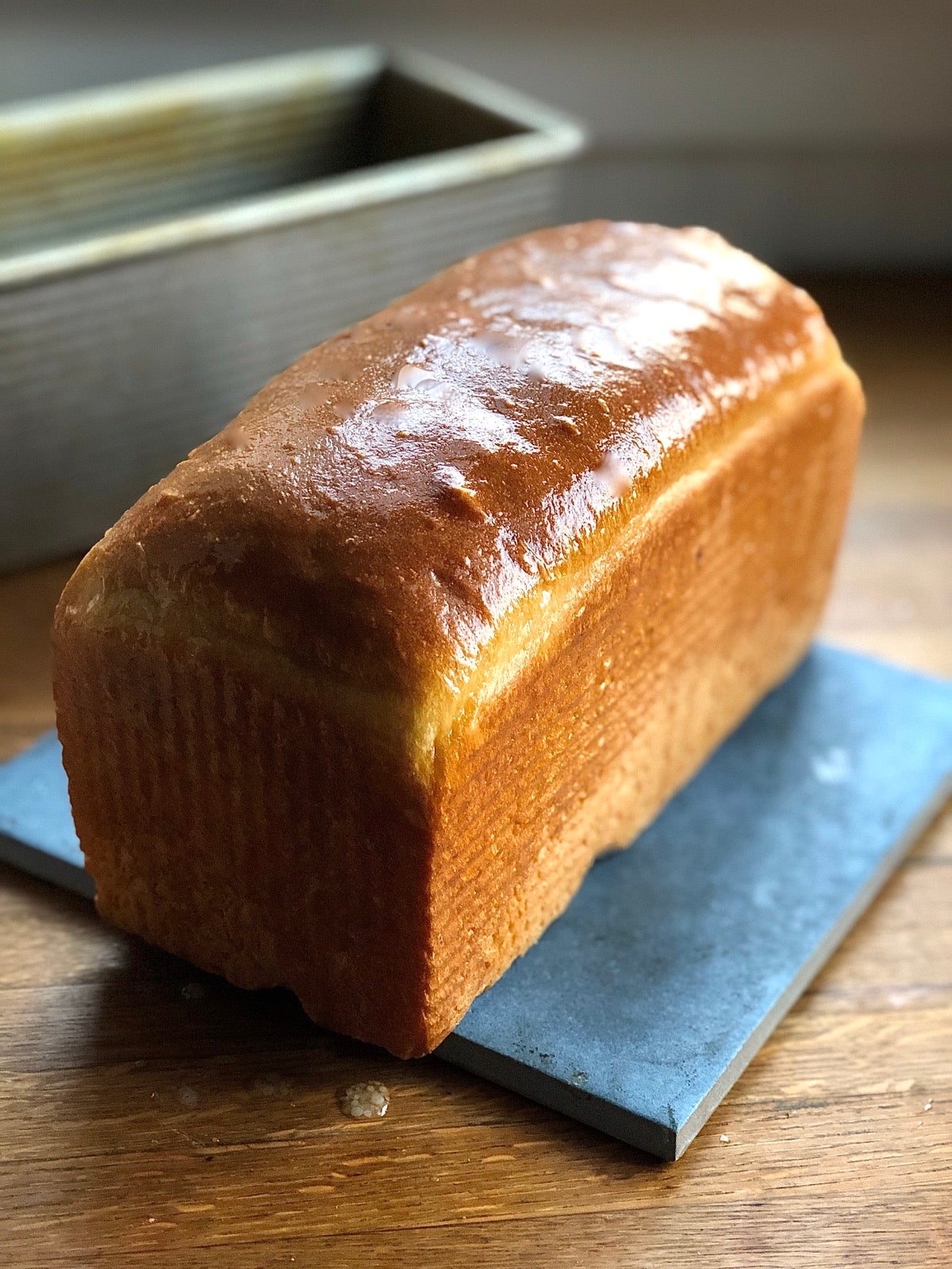 Loaf of hot bread just out of the oven brushed with melted butter.