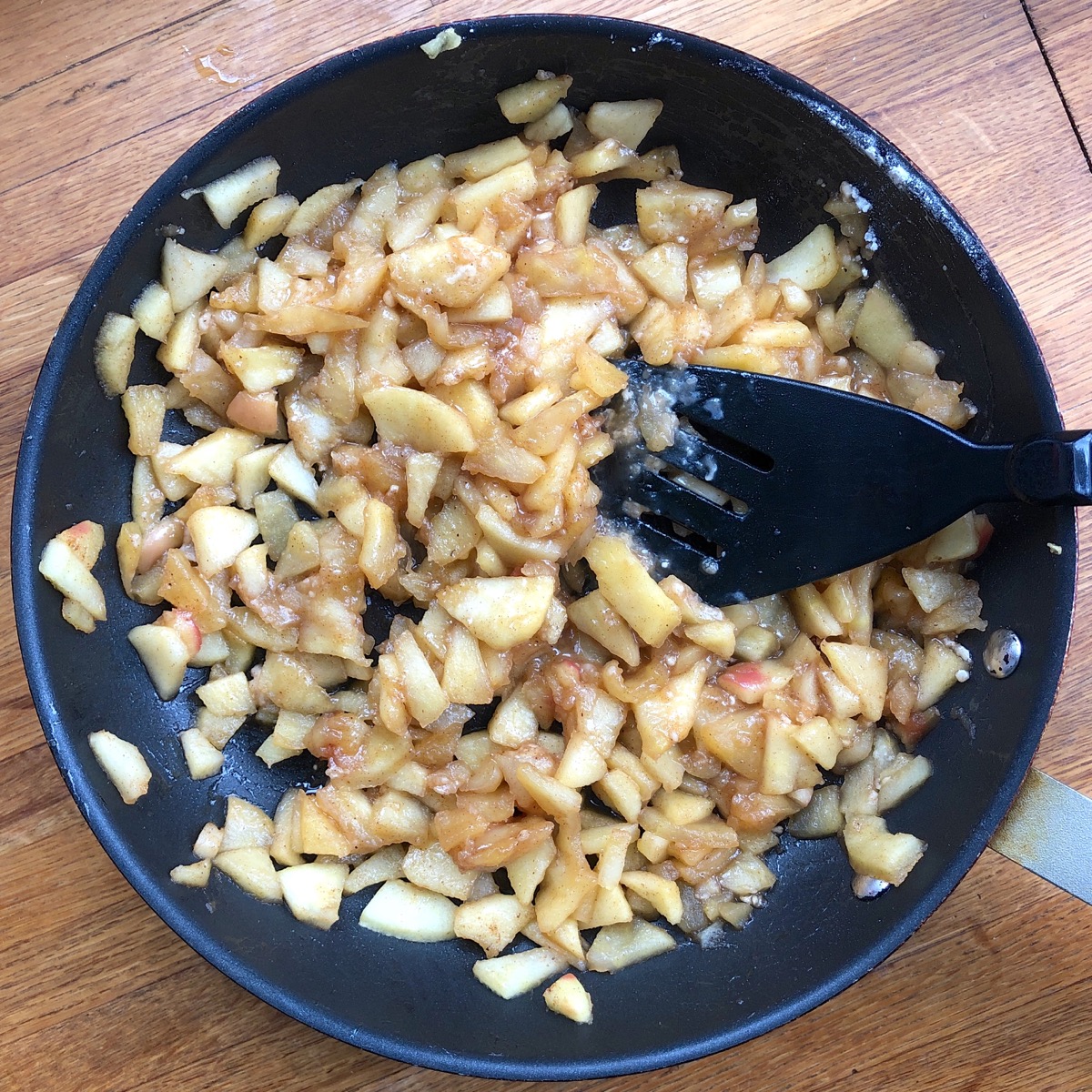 Diced apples gently fried in a large frying pan with butter and boiled cider.