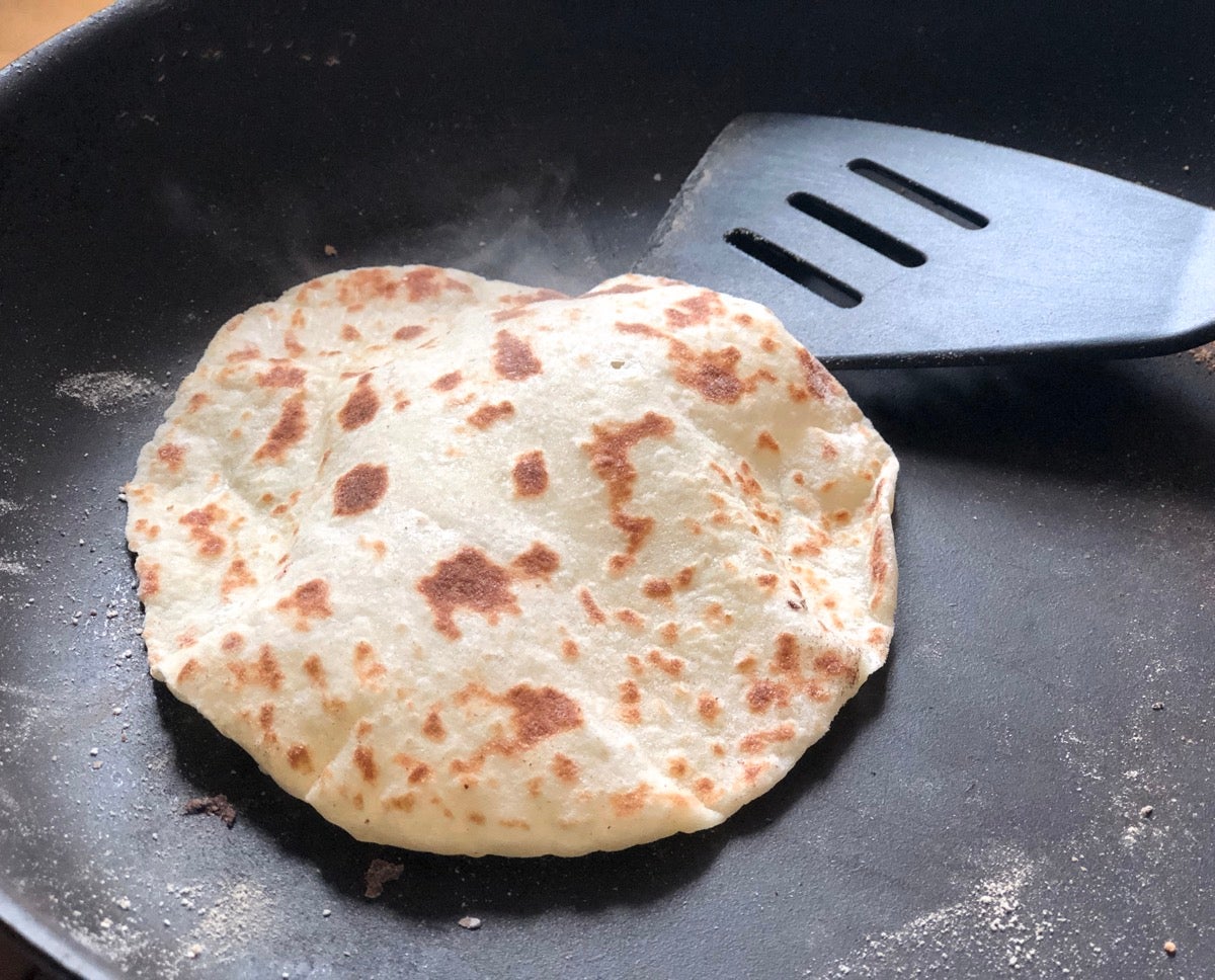 Lefse cooking in a frying pan