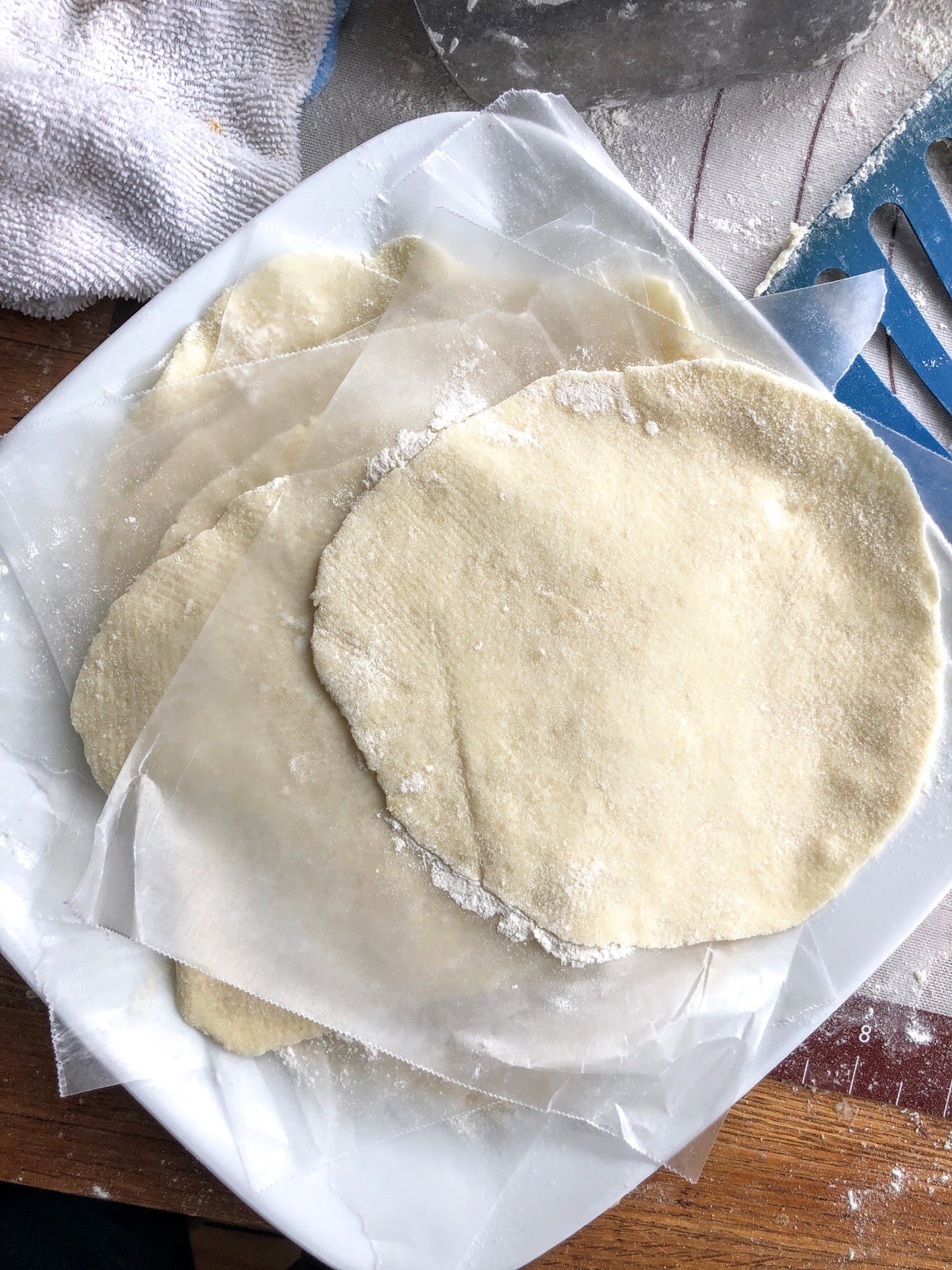 Rolled-out lefse fanned out on a plate prior to cooking.