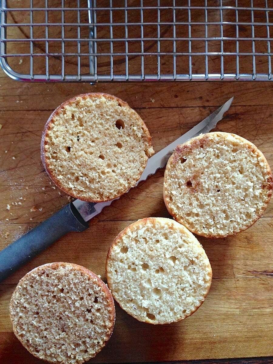 Doughnut muffins split around the circumference to show their inner texture.