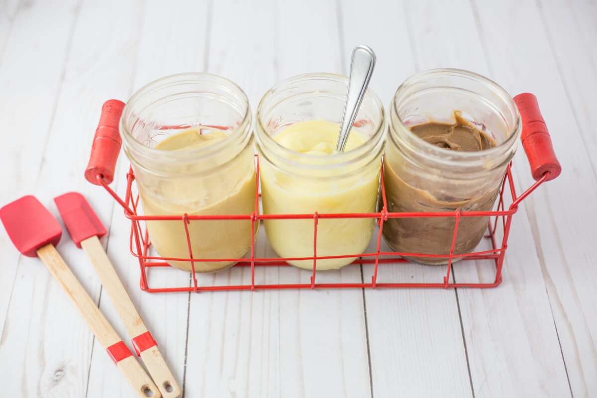 Three jars of pastry cream: caramel, lemon, and chocolate