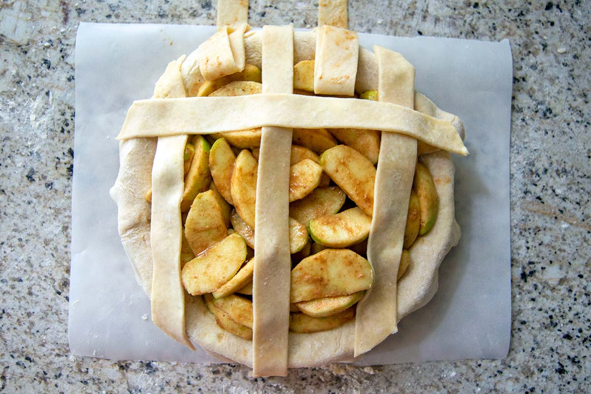 Pie with vertical strips folded back and one horizontal strip over filling