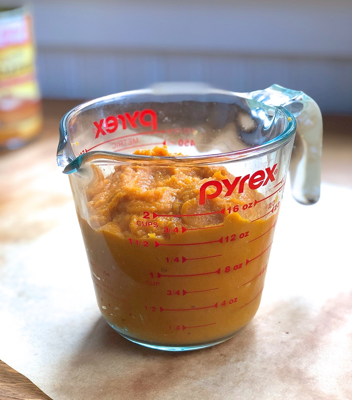 Glass measuring cup containing 1 3/4 cups pumpkin.