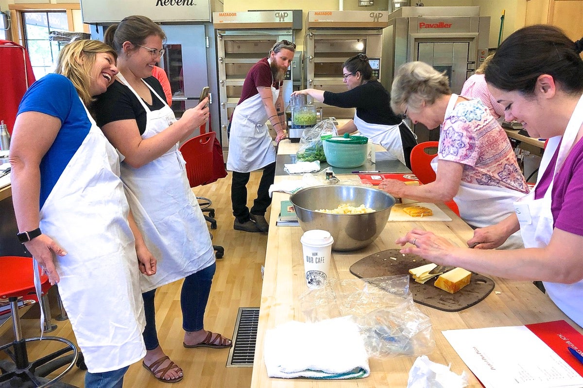 Women taking photos at a King Arthur Baking School class.