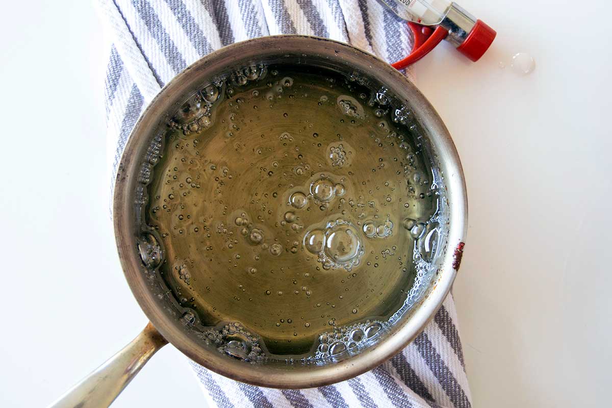 Boiling sugar mixture in saucepan