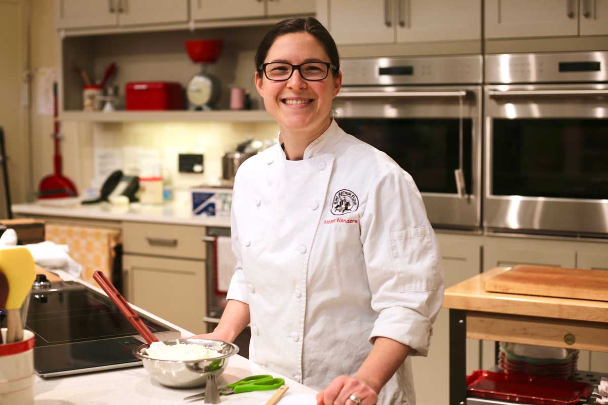 Mel Wanders behind the kitchen counter