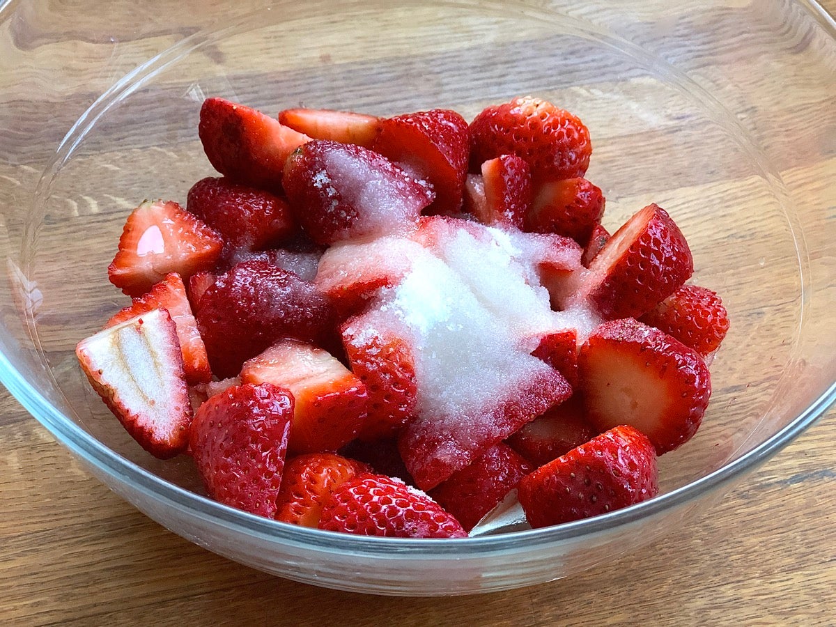 Cut strawberries, sugar, lemon juice, and a touch of salt in a glass bowl.