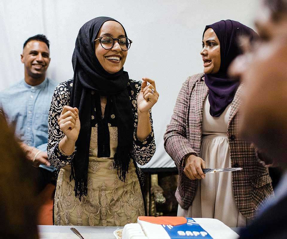 Naureen at a celebratory gathering with cake