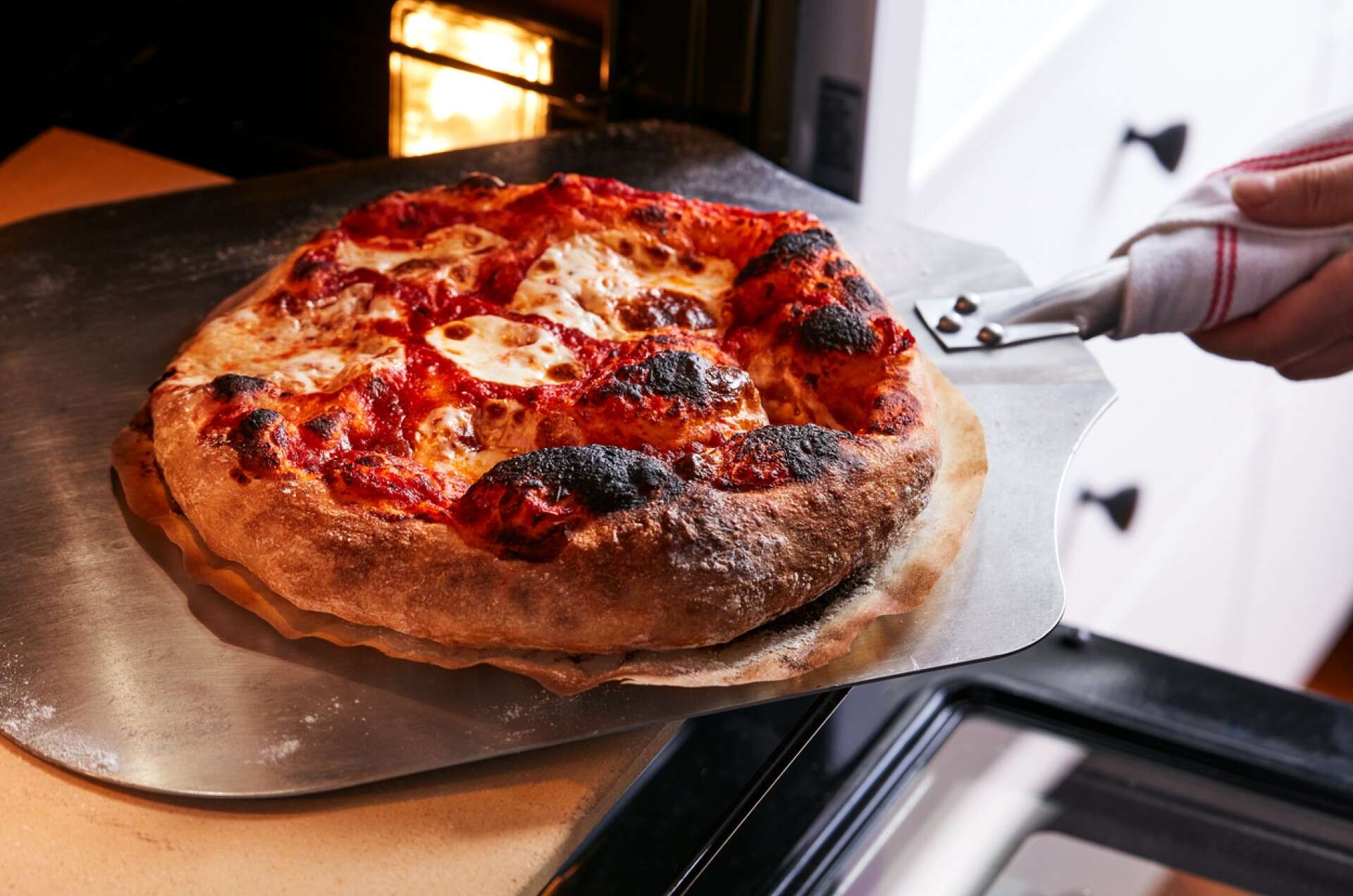 Neapolitan Pizza coming out of an oven