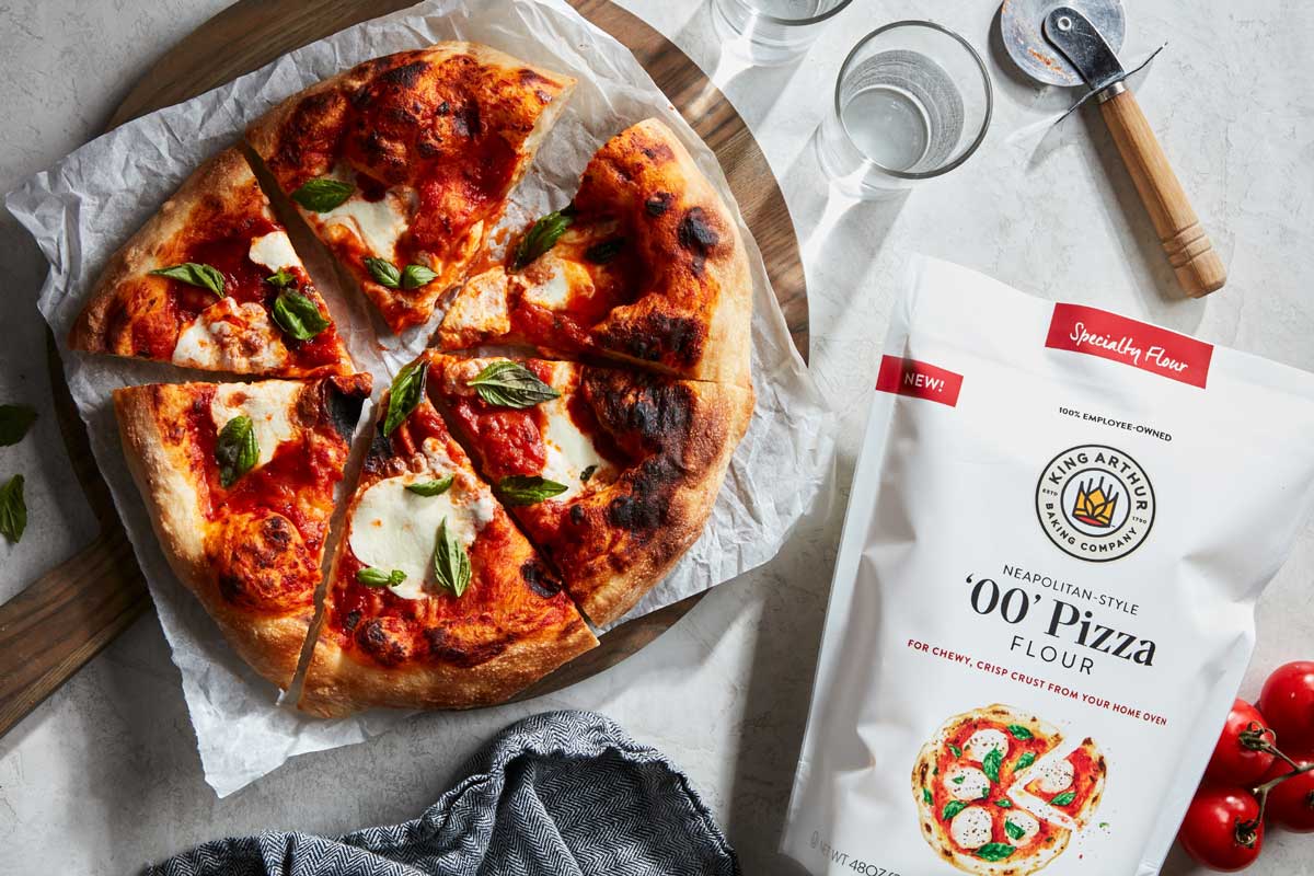 Neapolitan-style pizza next to bag of '00' Pizza Flour