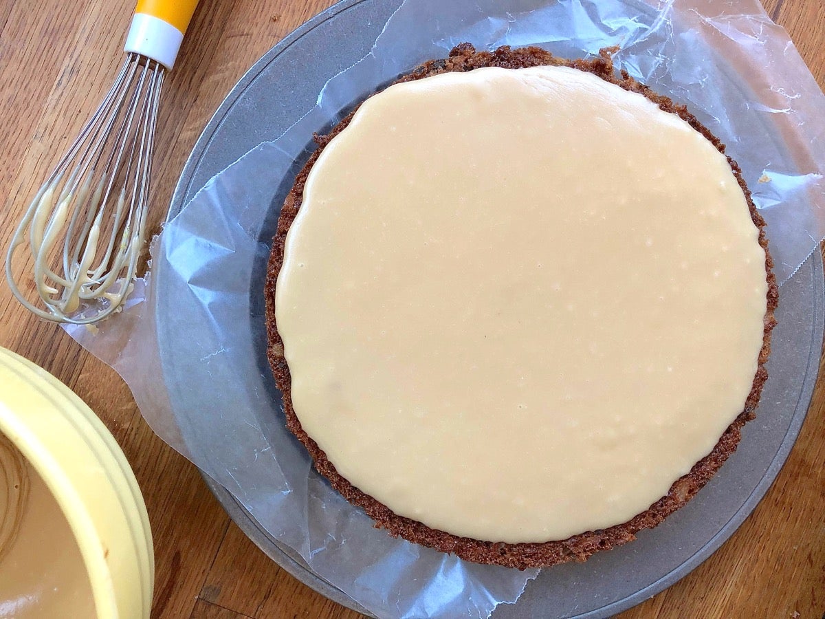 An 8" round apple cake frosted with brown sugar frosting.