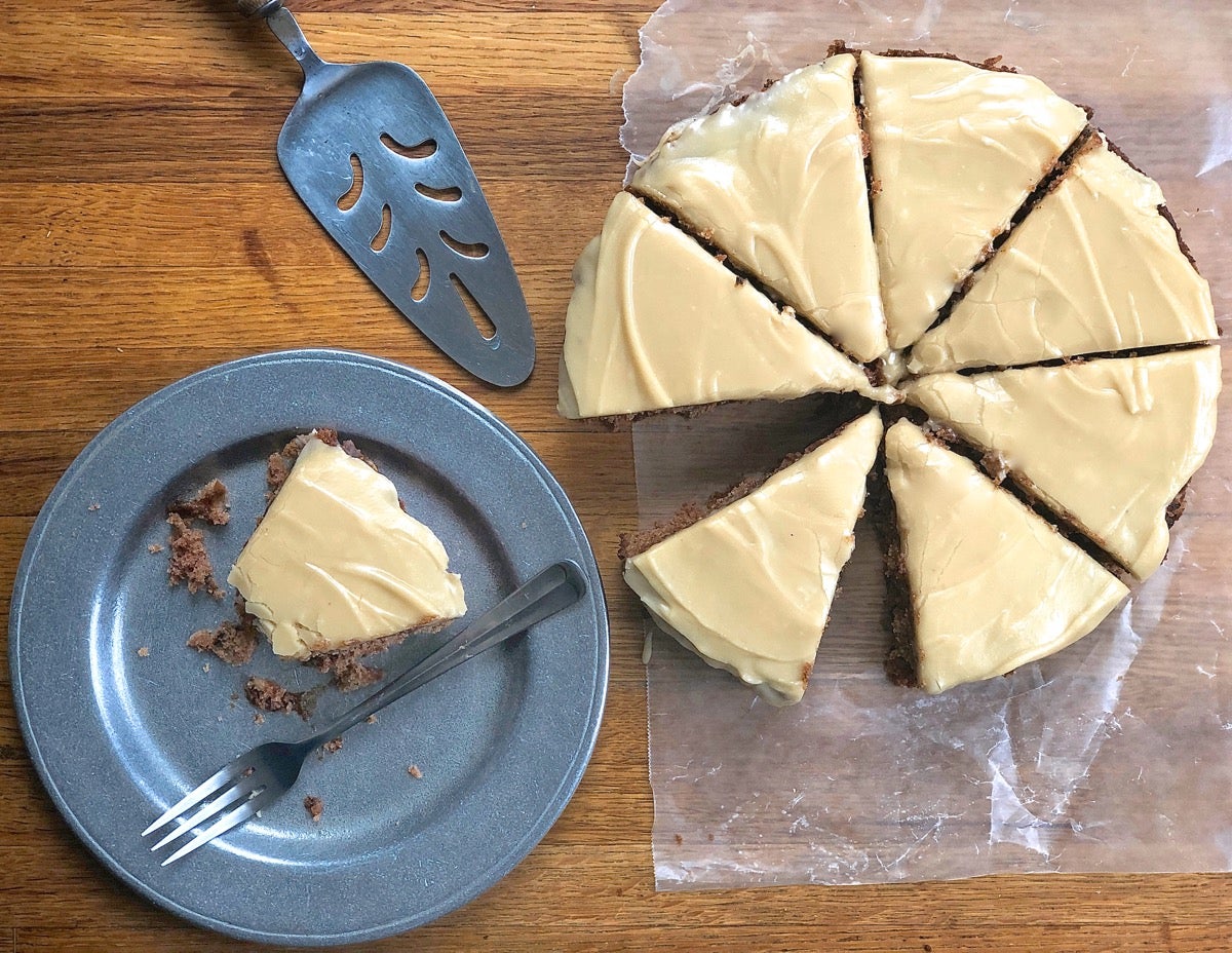 An 8" round apple cake cut into eight wedges, ready to serve.