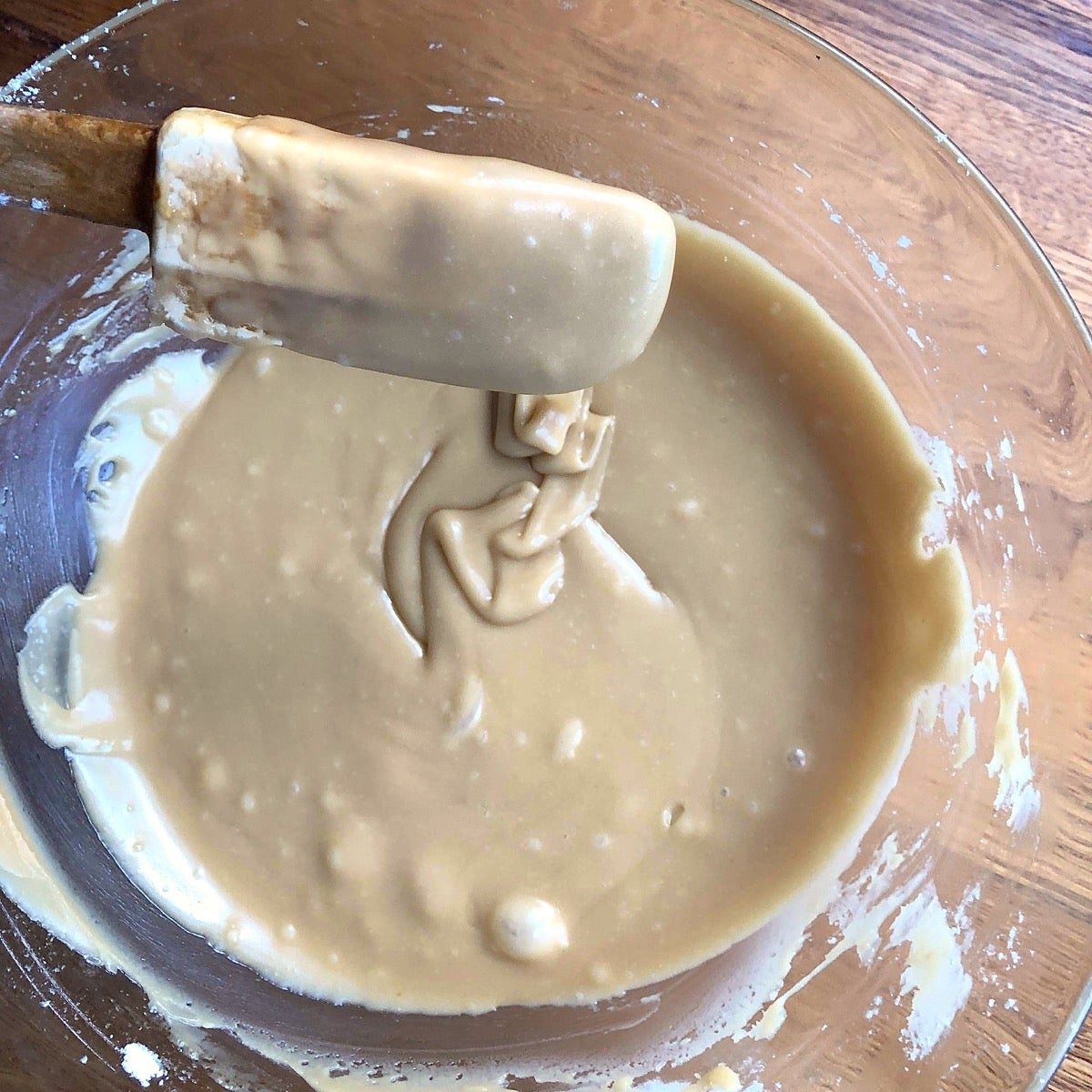 Brown sugar frosting in a bowl, ready to spread on apple cake.