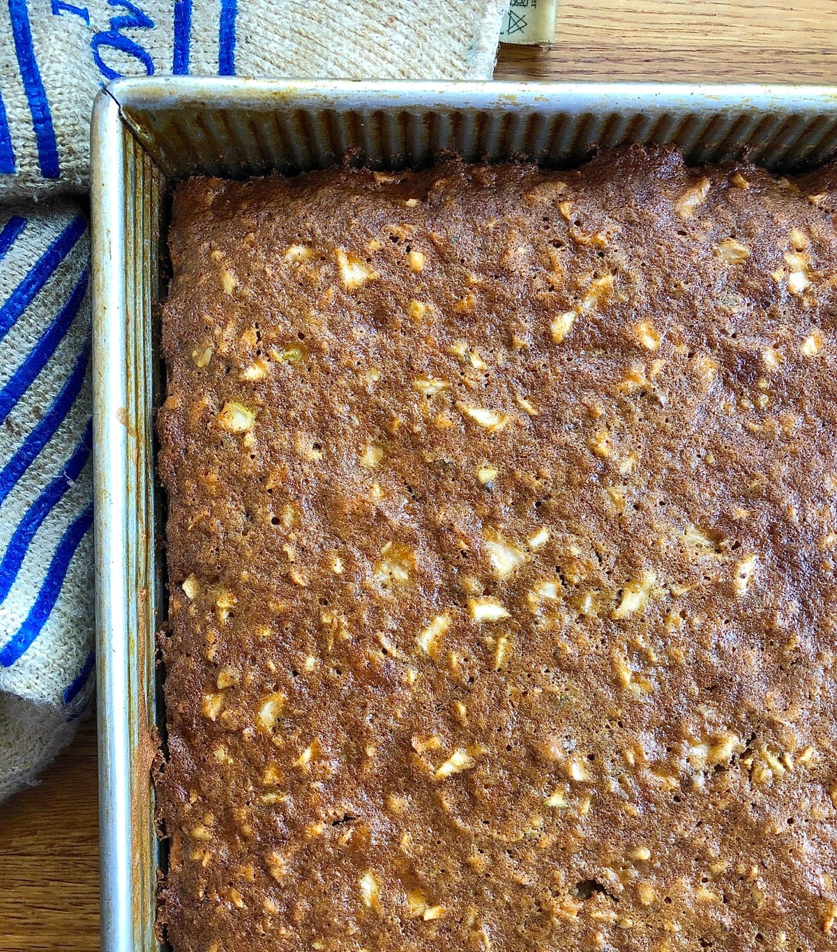 Apple cake baked in a 9" x 13" pan, ready to frost.