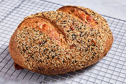 A freshly baked loaf of Parmesan Black Pepper Sourdough bread.