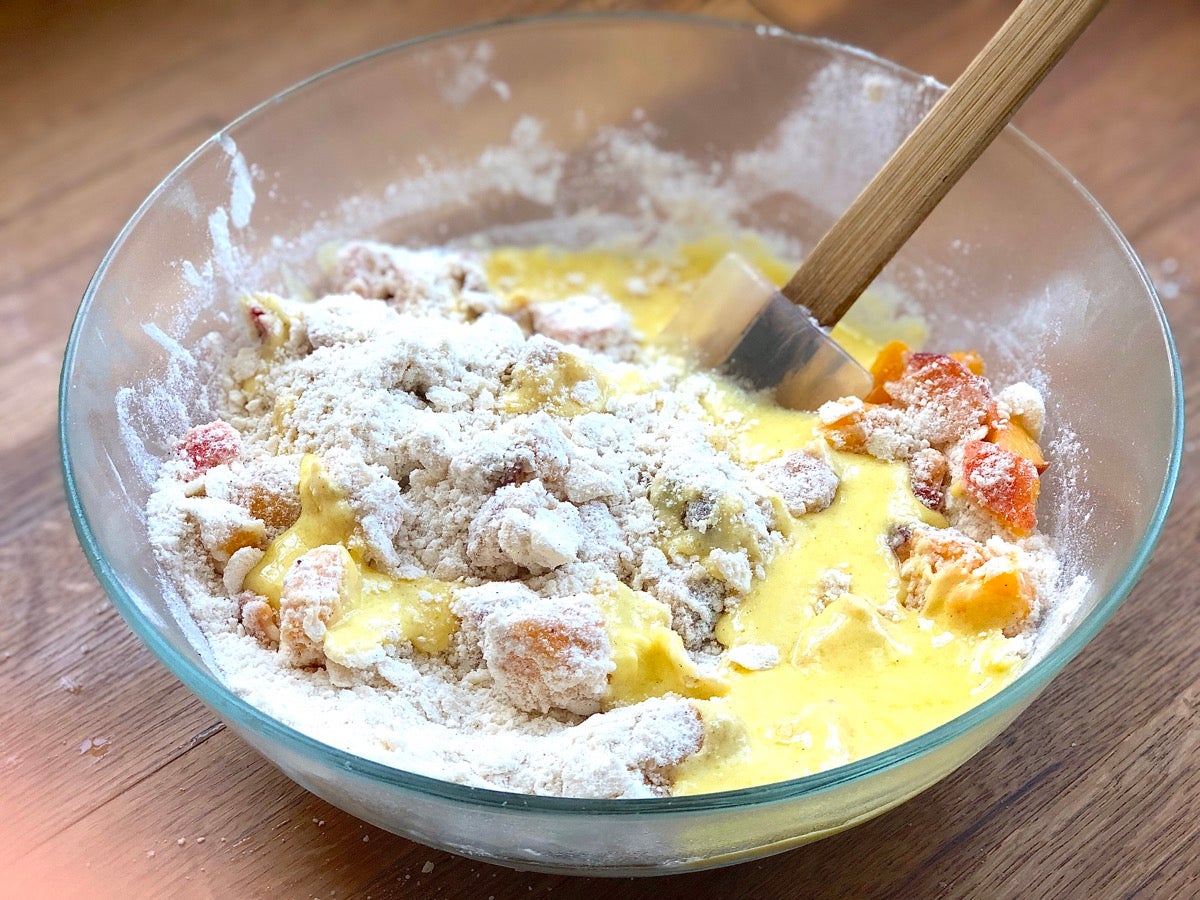 Fresh diced peaches plus liquid ingredients stirred into the sry ingredients for peach scones.