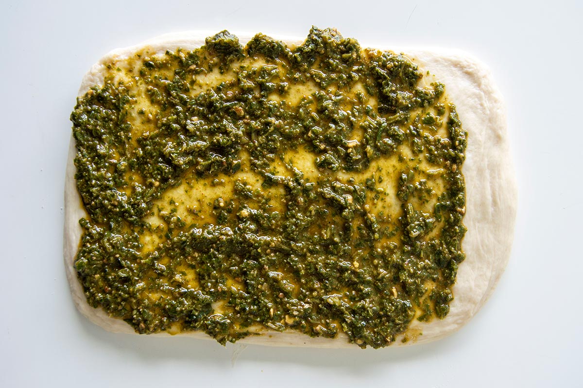 Rolls dough covered with pesto