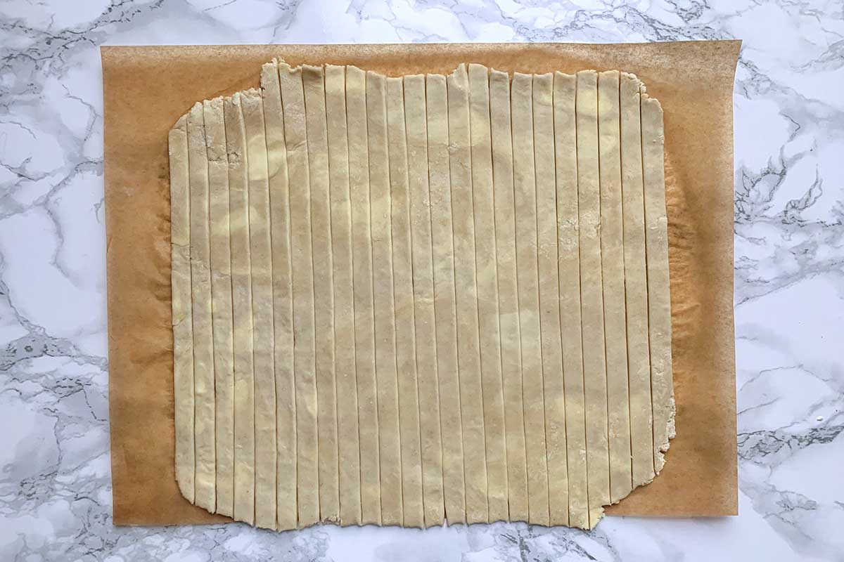 One square of dough cut into vertical strips 