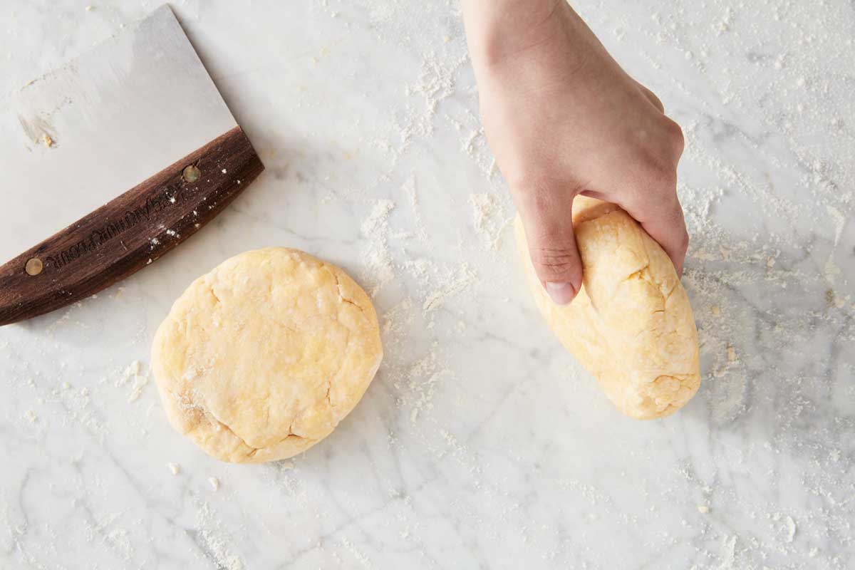 Rolling disc of pie dough on its edges