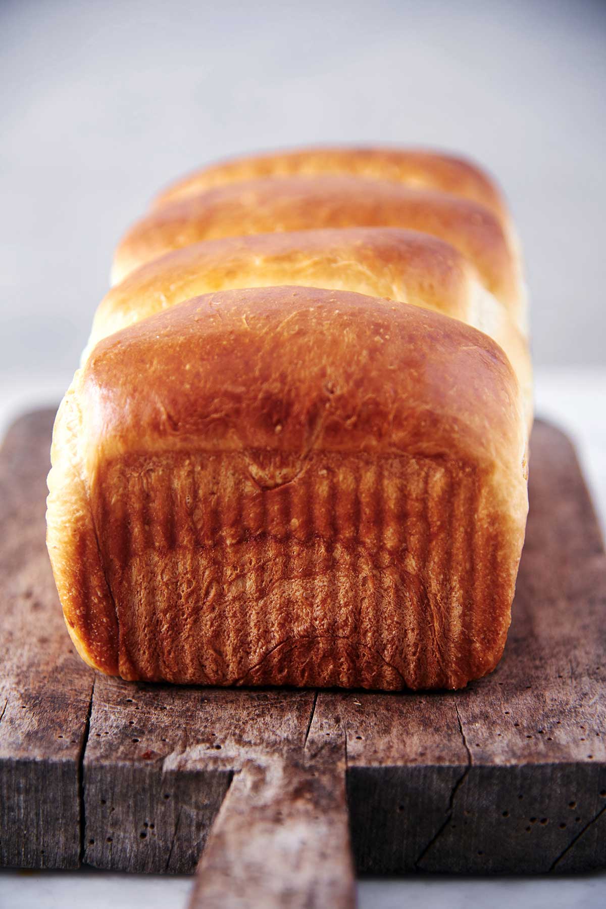 A loaf of golden brown Pillowy White Bread fresh from the oven