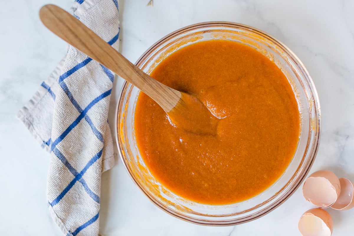 Pumpkin puree, eggs, and oil mixed together for a pumpkin Bundt cake