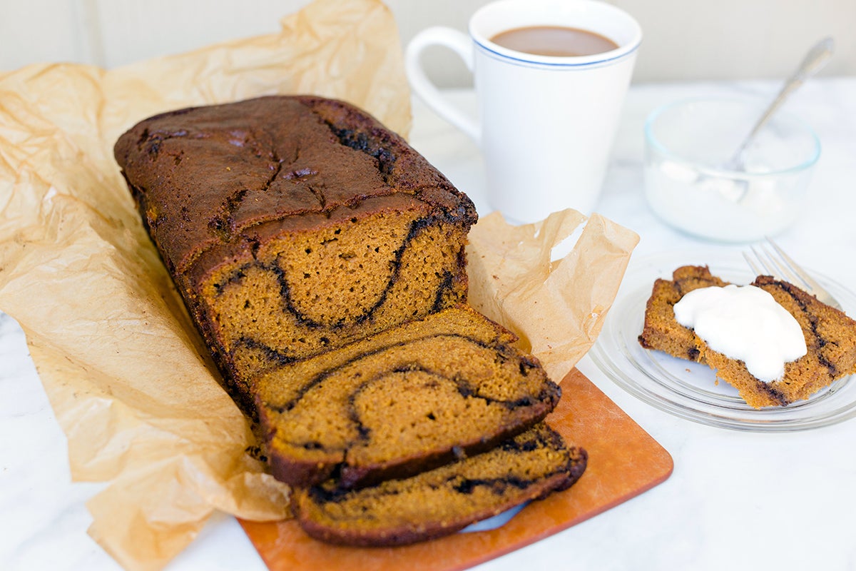 Pumpkin espresso loaf cake with a slice topped with whipped cream