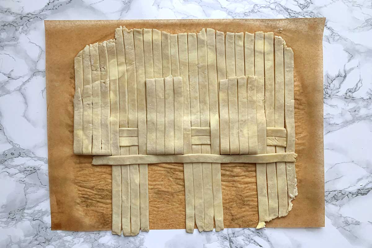 Same dough as previous image, with one horizontal strip of dough laid across