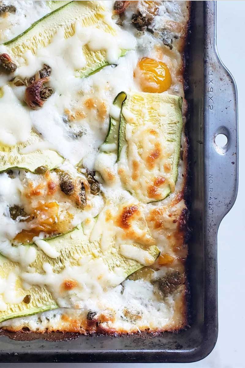 Baked rectangular pan pizza topped with burrata