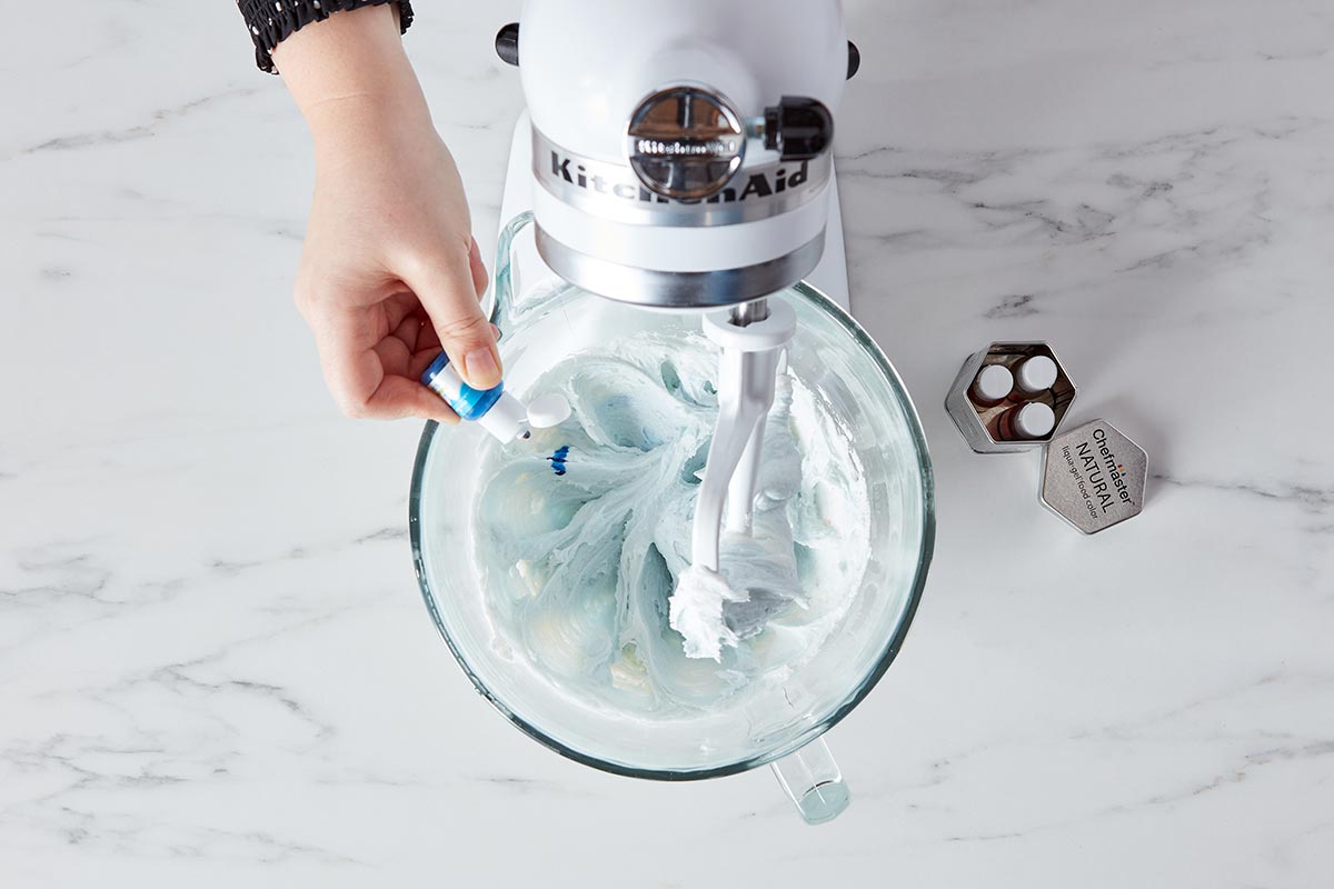 Adding coloring to frosting in mixing bowl