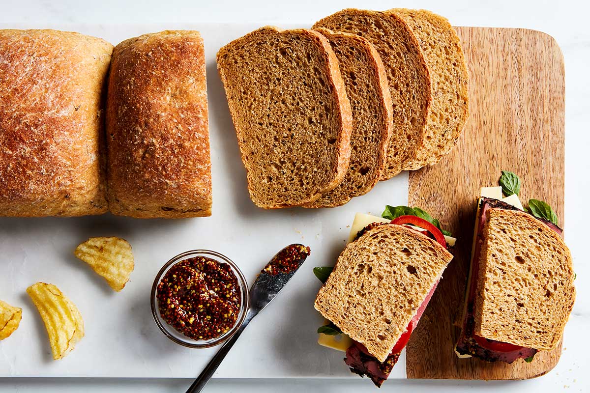 A loaf of classic rye bread cut into slices and made into sandwiches