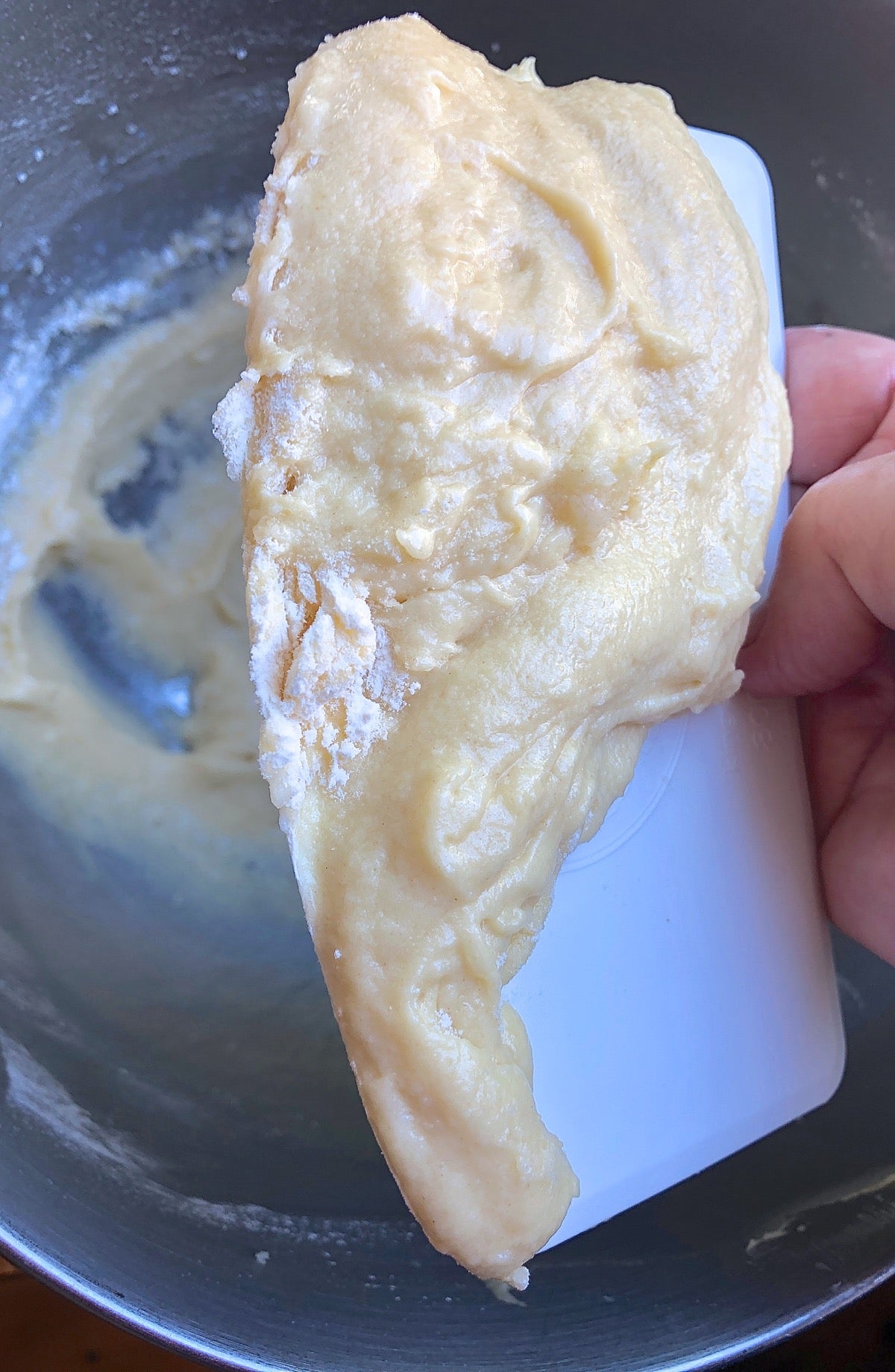 Sticky, poorly mixed cake batter scraped out of the bottom of a mixing bowl